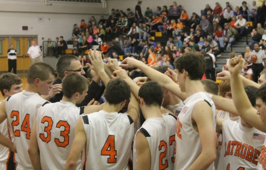 The Varsity Basketball team gathers together to cheer each other on ...