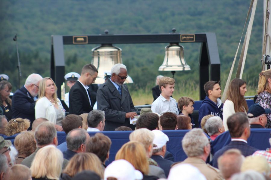 Family members of Flight 93 line up in front of the Bells of Remembrance.