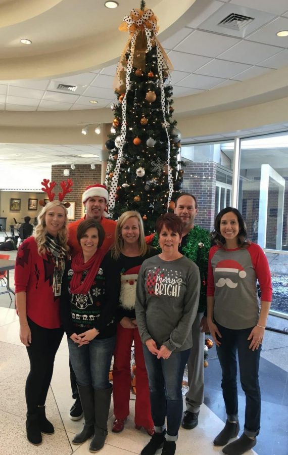 Latrobe Staff poses in front of the annual Christmas tree with Mrs. Sherwin. 
