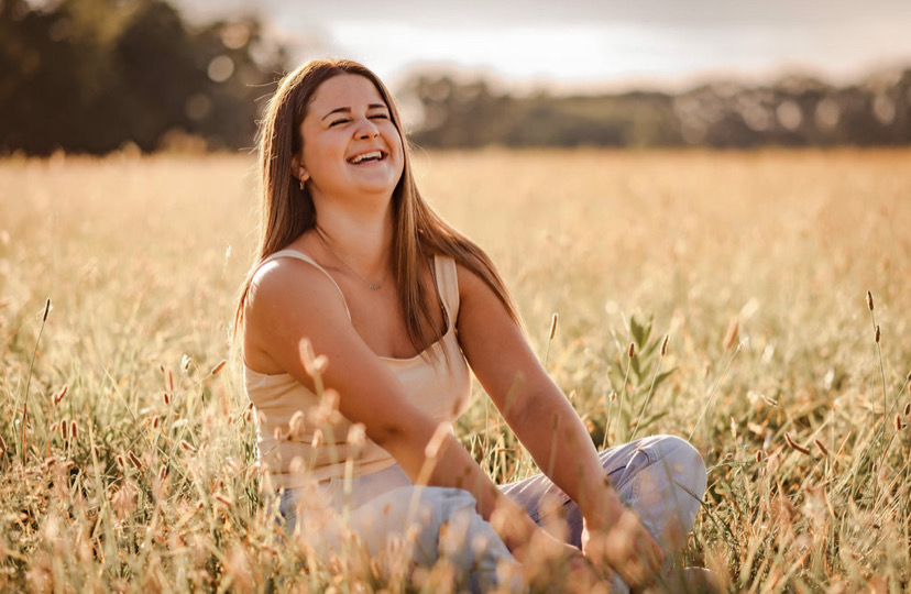 Giovanna Jones smiles as she soaks up the last rays of summer in late August of 2022. She took this time to take senior pictures in a beautiful field close to home. 