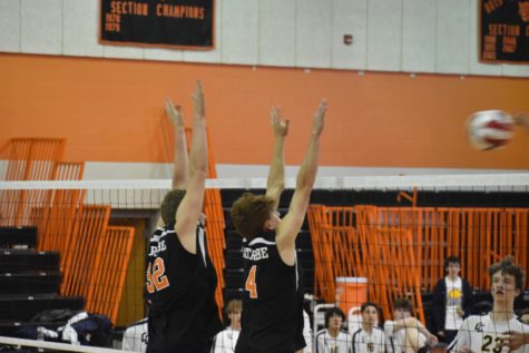 Nelson and Havrilla going up to block in an intense matchup section matchup during the 2022 volleyball season.