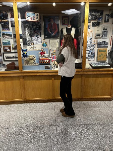 Gracie admiring the beauty of the Mr. Rogers display in Greater Latrobe High School.