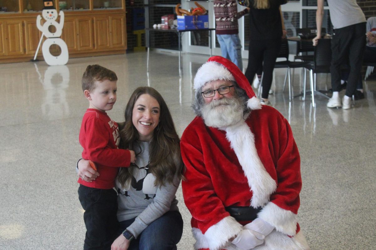 Mrs+Donahue+and+her+son+pose+for+a+picture+with+Santa+Claus%21+