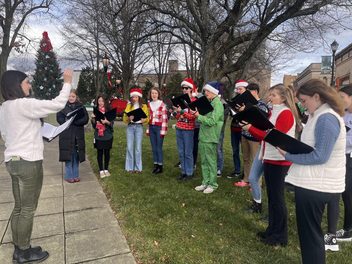 

Olivia Blackmore conducting the Chamber Choir in downtown Latrobe at the Holly Jolly festival.  