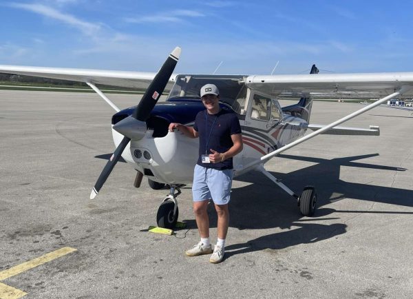 Eliott  Kintz poses in front of his 1978 Cessna 172. This plane allows him the training so that he can get to new levels of aviation. 