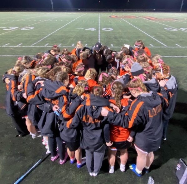 Girls lacrosse team wore pink ribbons in their hair in support of their coach, Kaytie Costic