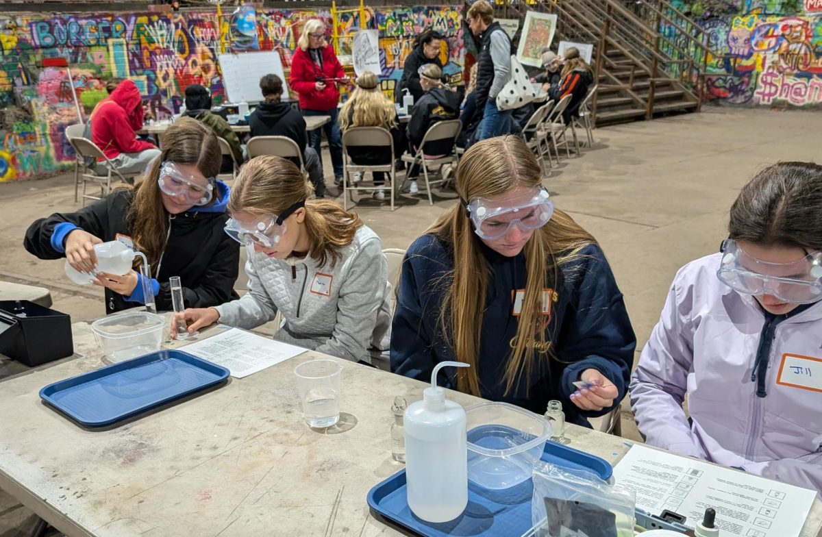 Zuzanna Bugalska, Marie Patterson, Destini Homan and Jill Riggs perform water quality tests.