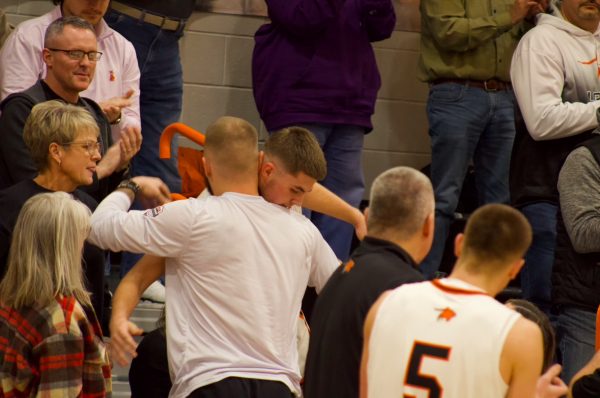 Max Butler hugs his older brother, Austin Butler, after scoring his 1,000th point against Albert Gallatin.