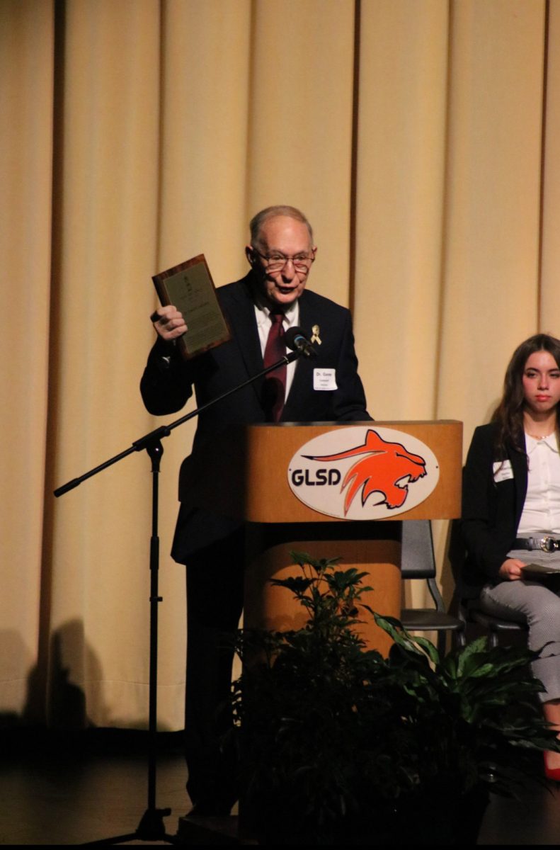 Dr. Leonard stands to his speech as the 2025 Art Gala's Honoree.